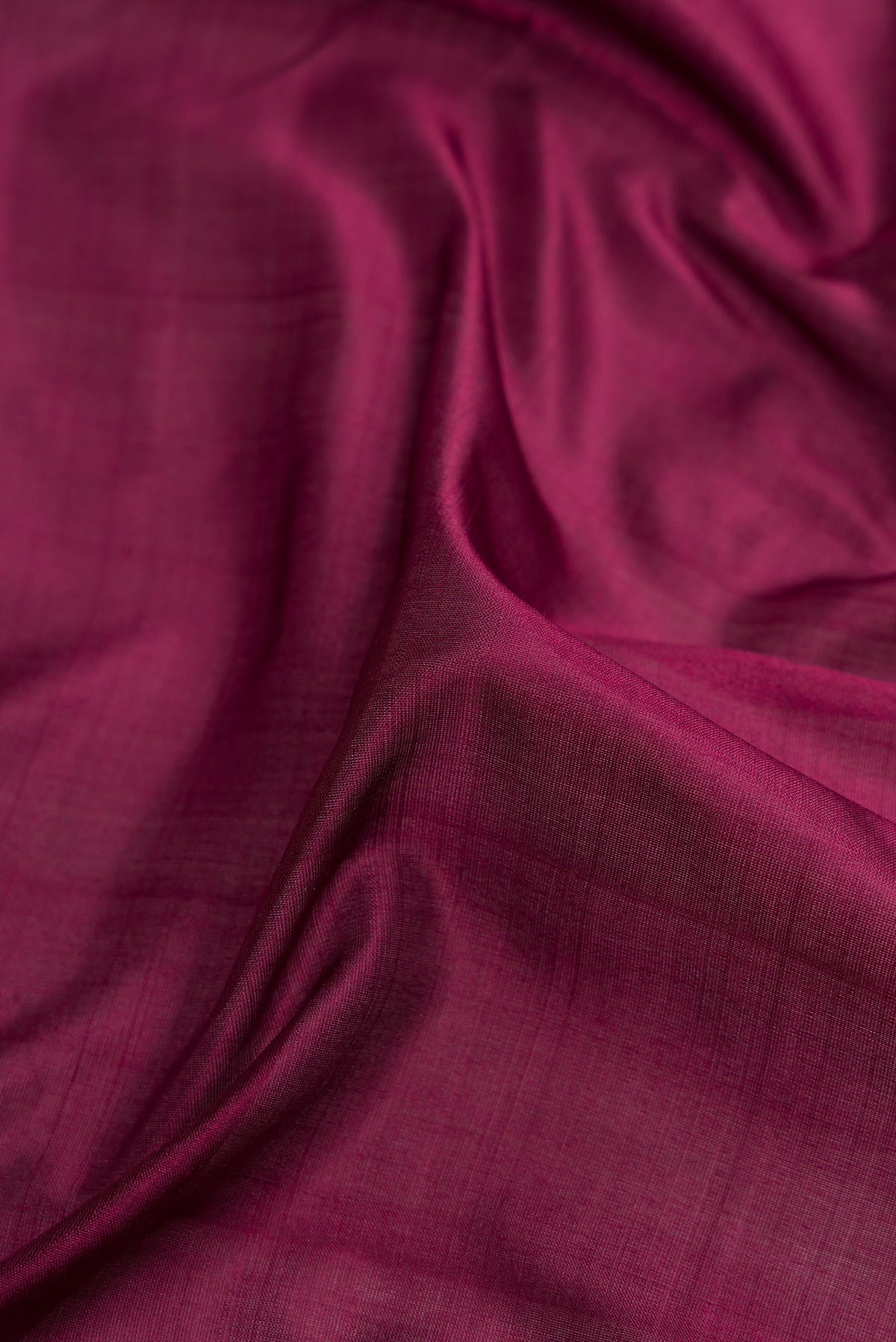 Close up of Burgundy Dual Tone Kanjivaram Silk Nine Yards Saree with Plain Body and Zari Border.  displaying folds
