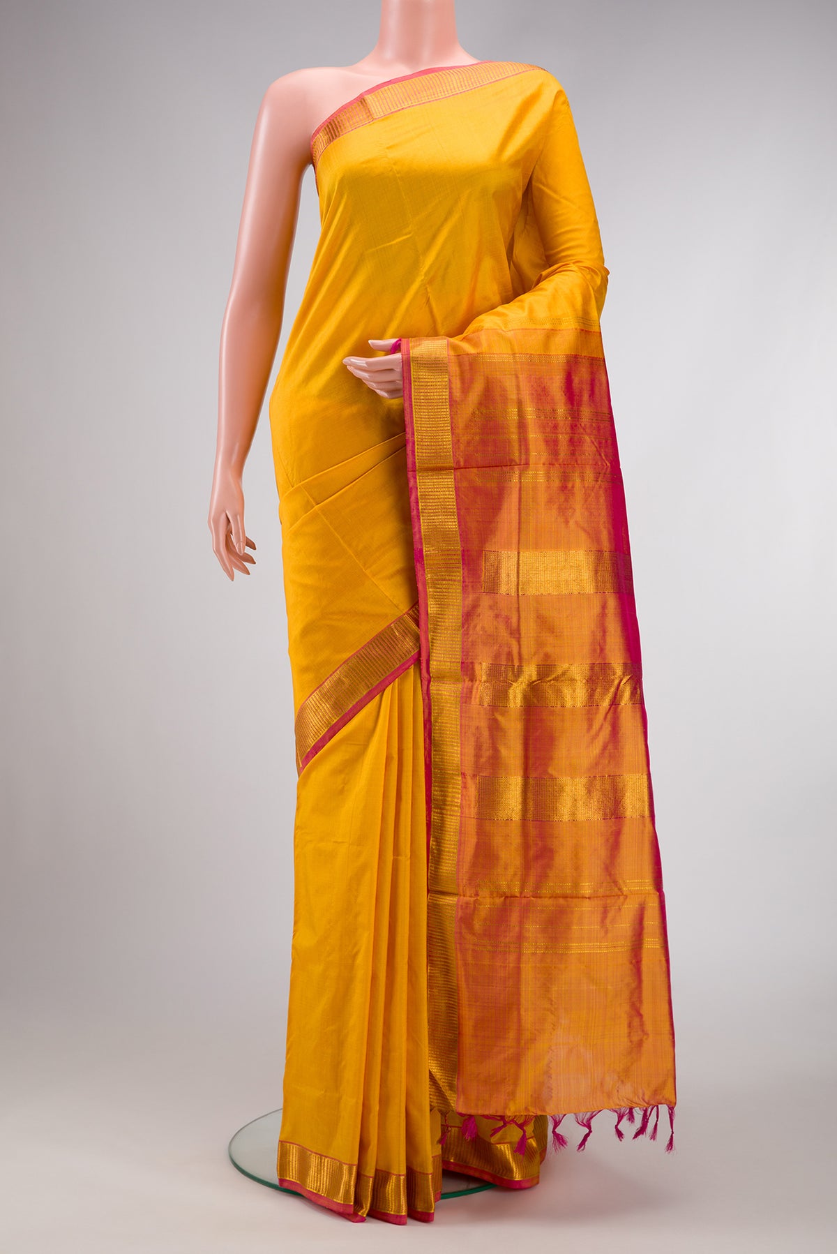 Mustard Dual Tone Kanchipuram Silk Nine Yards Saree with Plain Body and Zari Border.  displayed on a mannequin