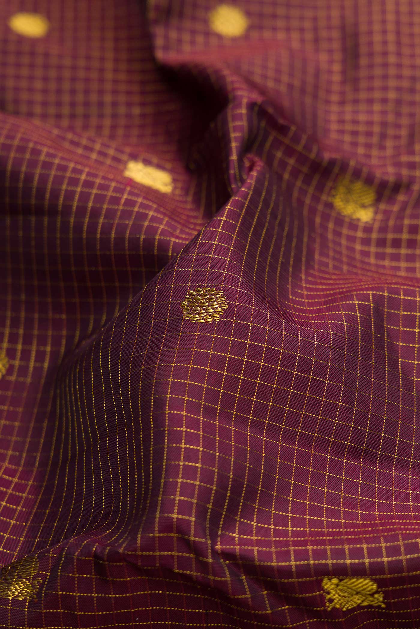 Close up of Coffee Brown Dual Tone Kanchipuram Silk Saree with Zari Butta on the body and Zari Border.  displaying folds