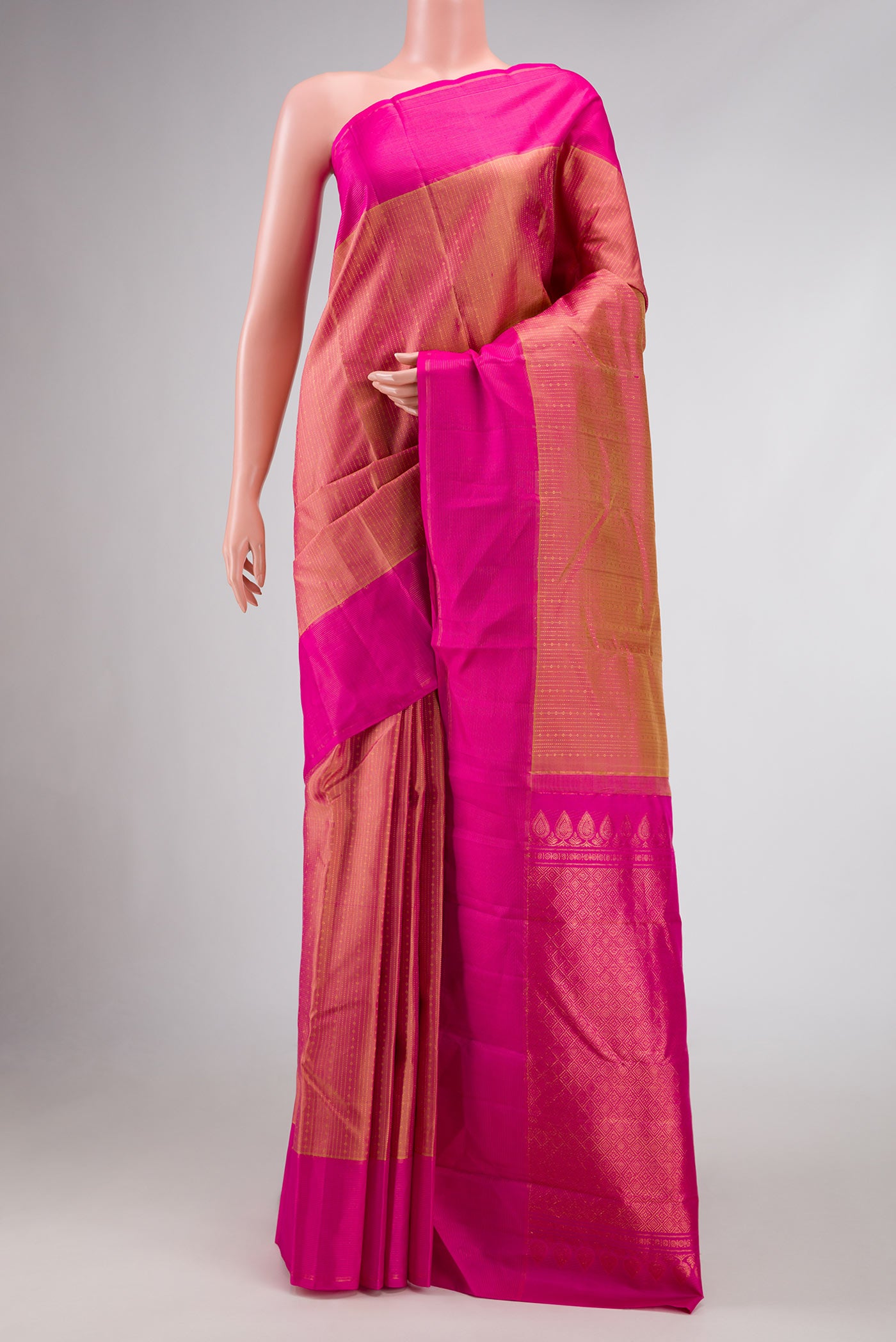 Golden Peach Dual Tone Kanchipuram Silk Saree with Stripes on the body and Zari Border.  displayed on a mannequin