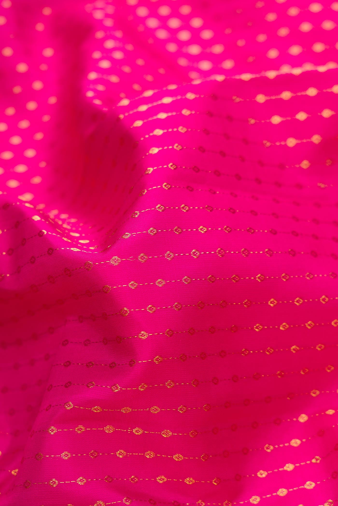 Close up of Pink Dual Tone Kanchipuram Silk Saree with Stripes on the body and Zari Border.  displaying folds