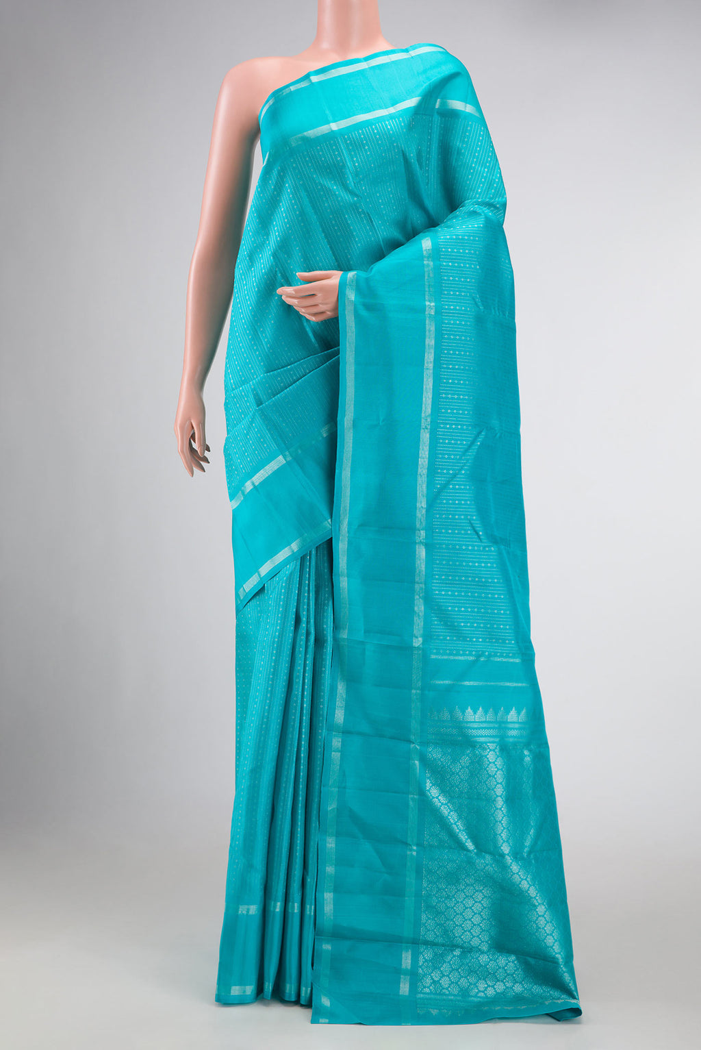Light Blue Dual Tone Kanchipuram Silk Saree with Stripes on the body and Zari Border displayed on a mannequin