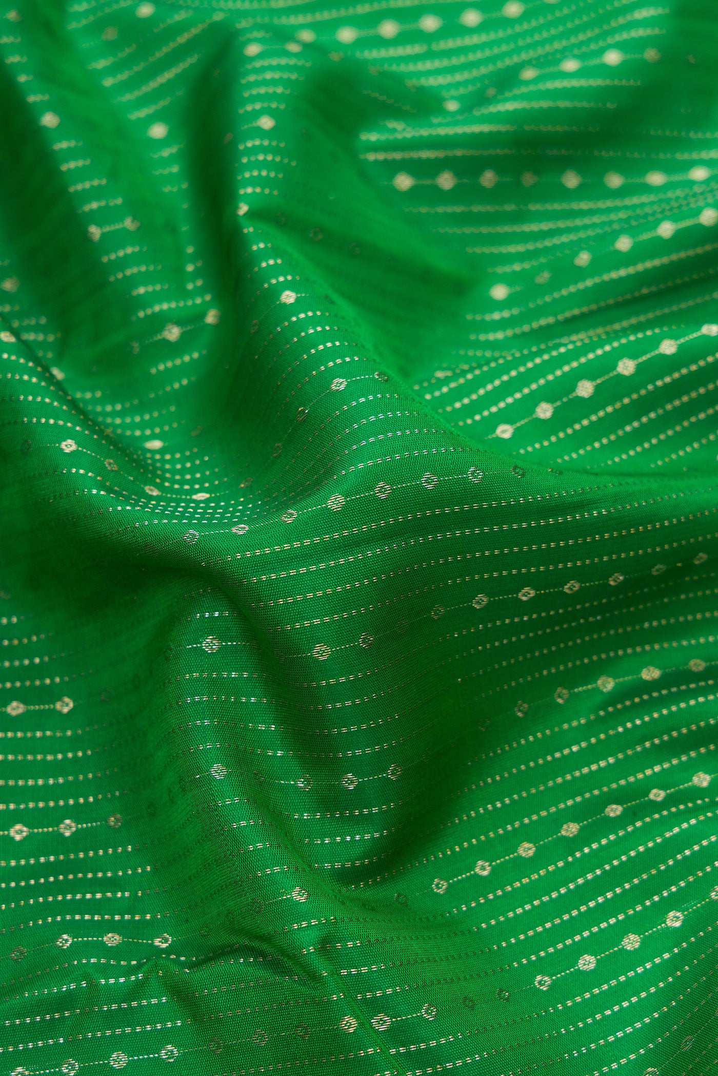 Close up of Bottle Green Dual Tone Kanchipuram Silk Saree with Stripes on the body and Zari Border.  displaying folds