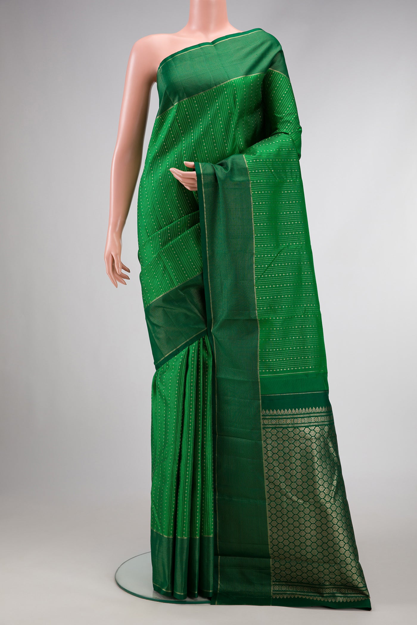 Bottle Green Dual Tone Kanchipuram Silk Saree with Stripes on the body and Zari Border.  displayed on a mannequin