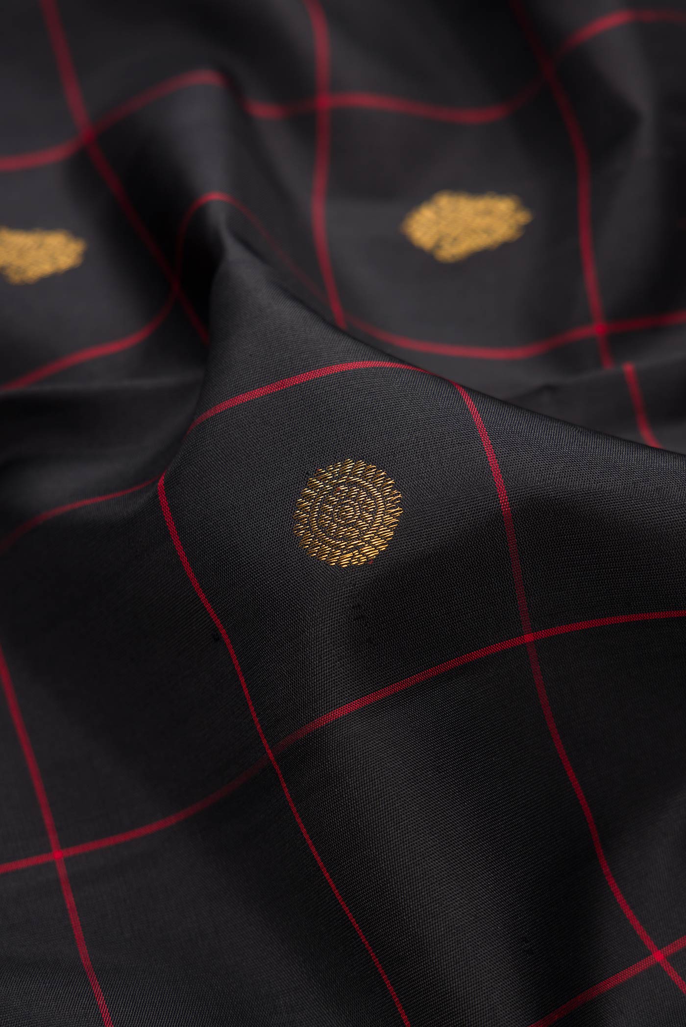 Close up of Black Dual Tone Kanchipuram Silk Saree with Checked design on the body and Thin Zari Line.  displaying folds