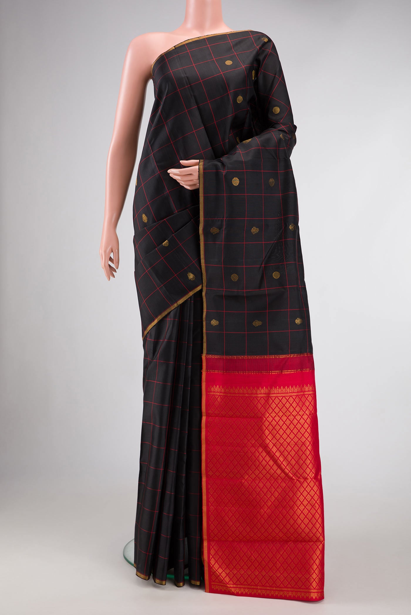 Black Dual Tone Kanchipuram Silk Saree with Checked design on the body and Thin Zari Line.  displayed on a mannequin
