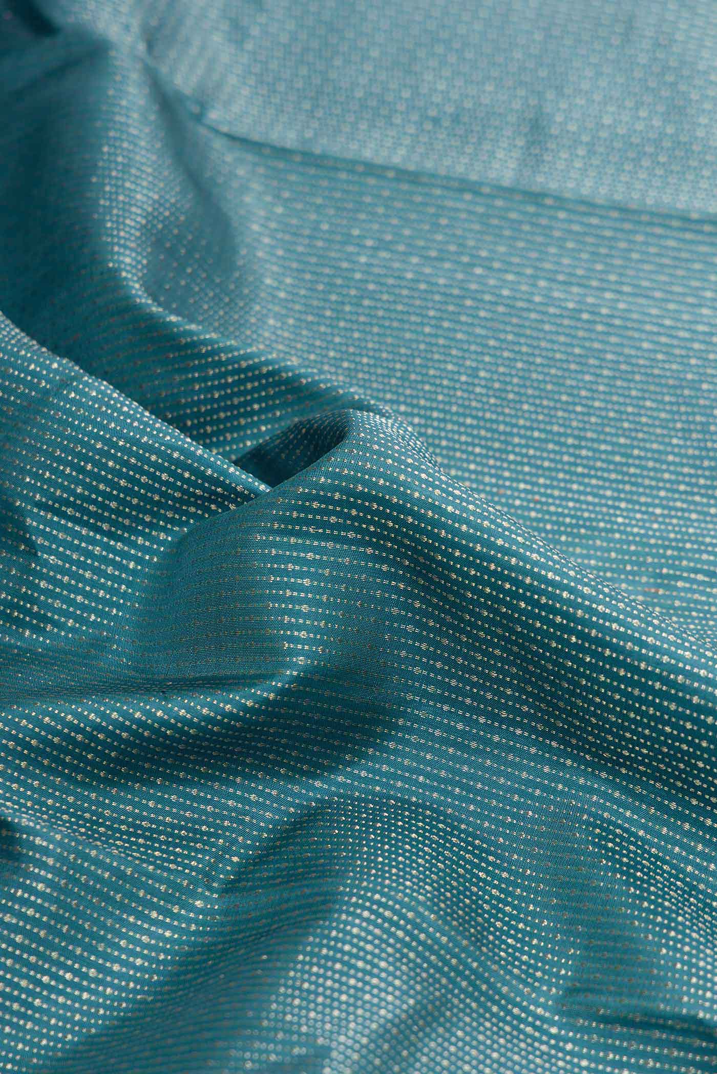 Close up of Blue Dual Tone Soft Silk Saree with Stripes on the body and Fancy Border displaying folds