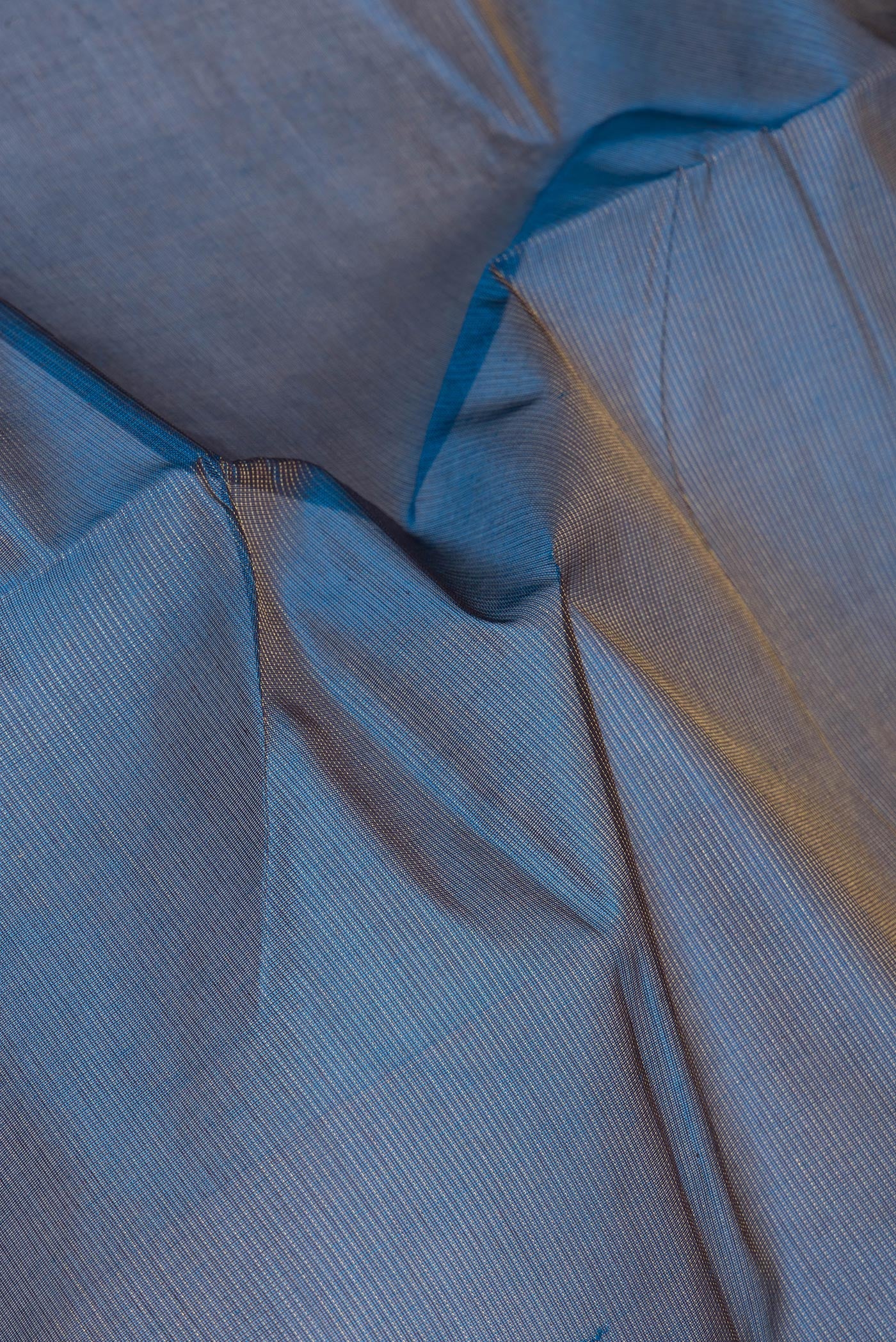 Close up of Peacock Blue Silk Cotton Saree with Stripes on the body and Zari Border.  displaying folds