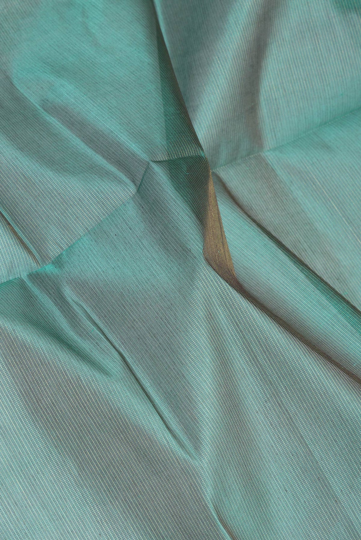 Close up of Green Silk Cotton Saree with Stripes on the body and Zari Border.  displaying folds