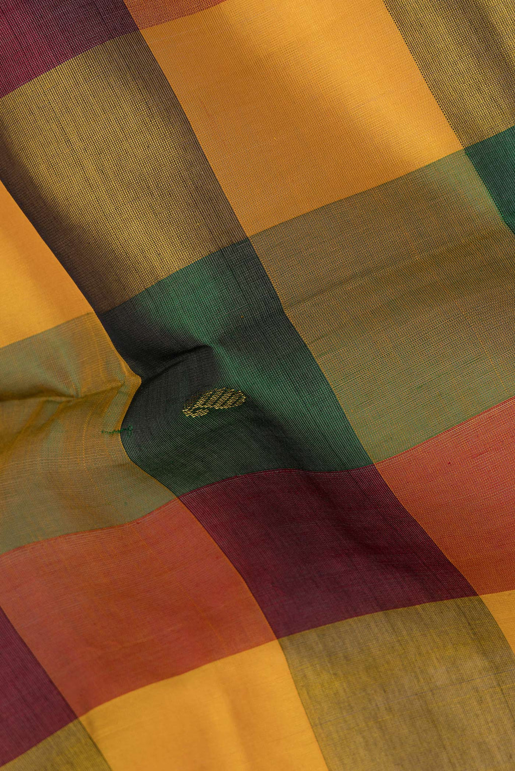 Close up of Multi Color Silk Cotton Saree with Zari Butta on the body and Zari Border.  displaying folds