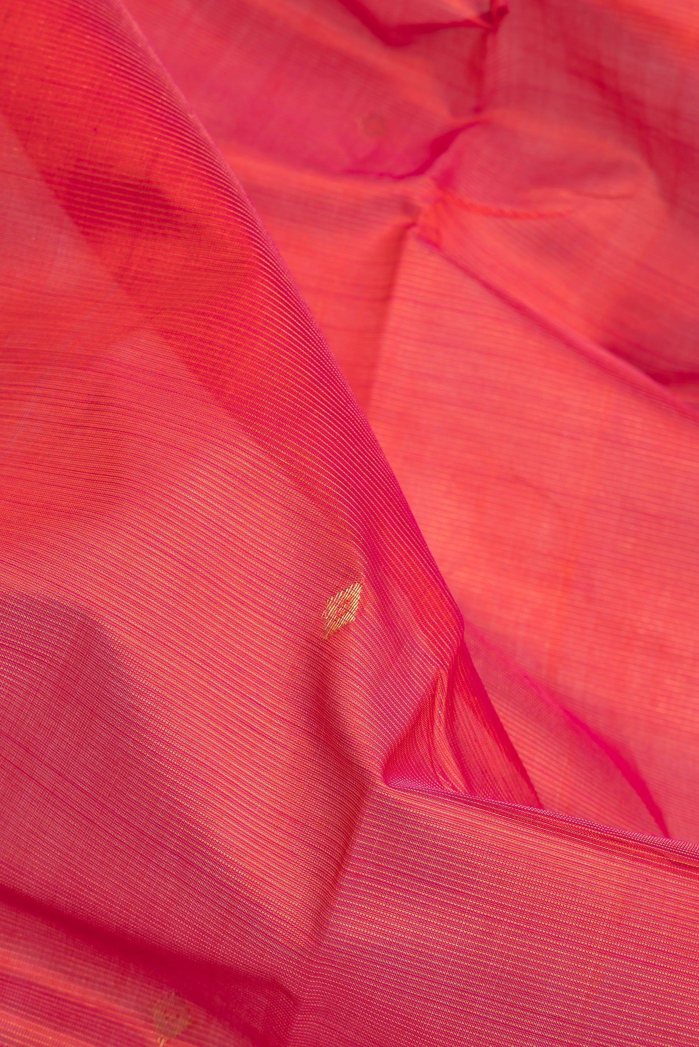 Close up of Red Silk Cotton Saree with Stripes on the body and Zari Border.  displaying folds