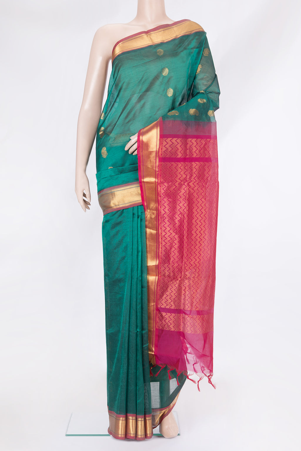 Green Silk Cotton Saree with Zari Butta on the body and Zari Border.  displayed on a mannequin