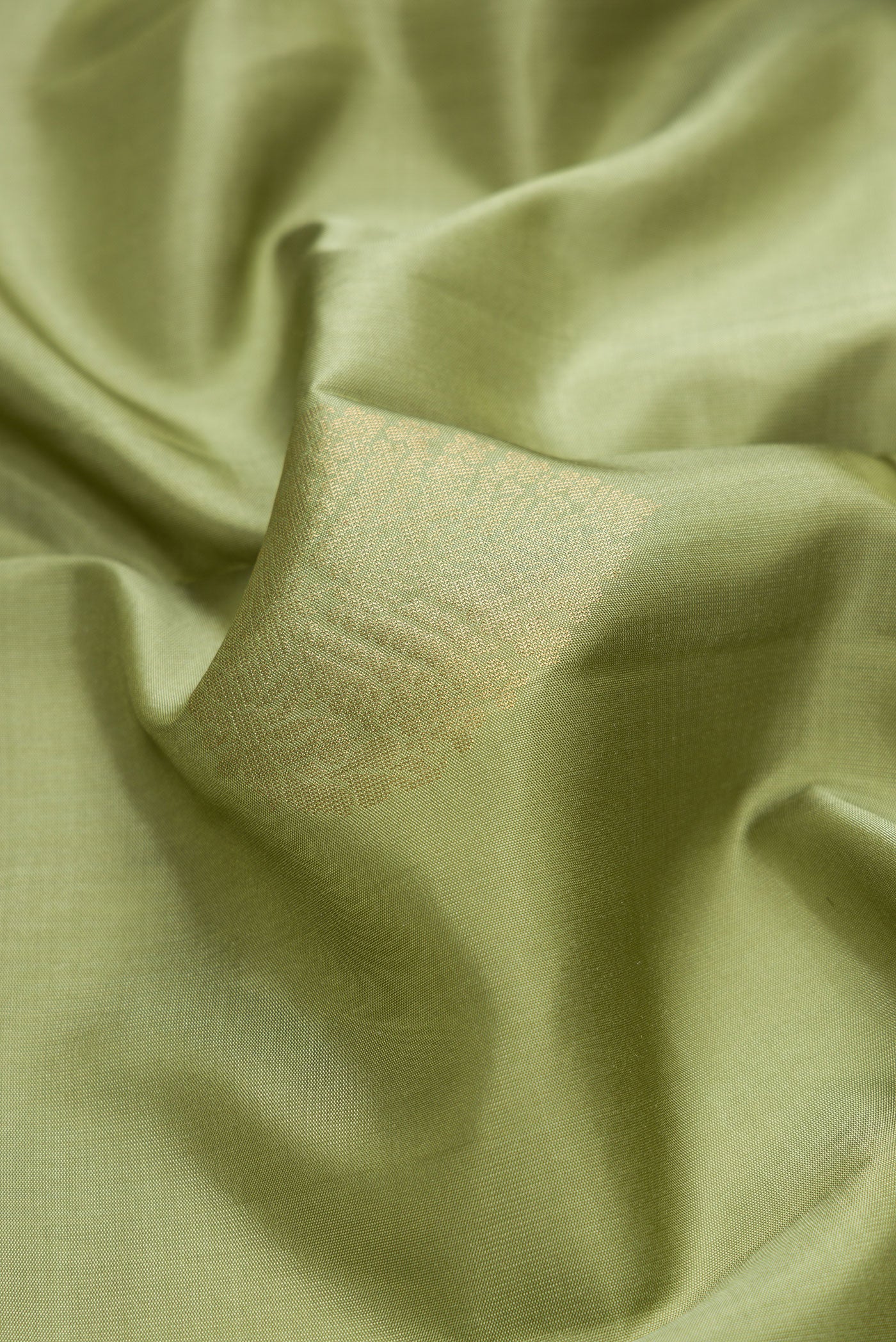 Close up of Mehandi Green Dual Tone Soft Silk Saree with Zari Butta on the body and Zari Border.  displaying folds