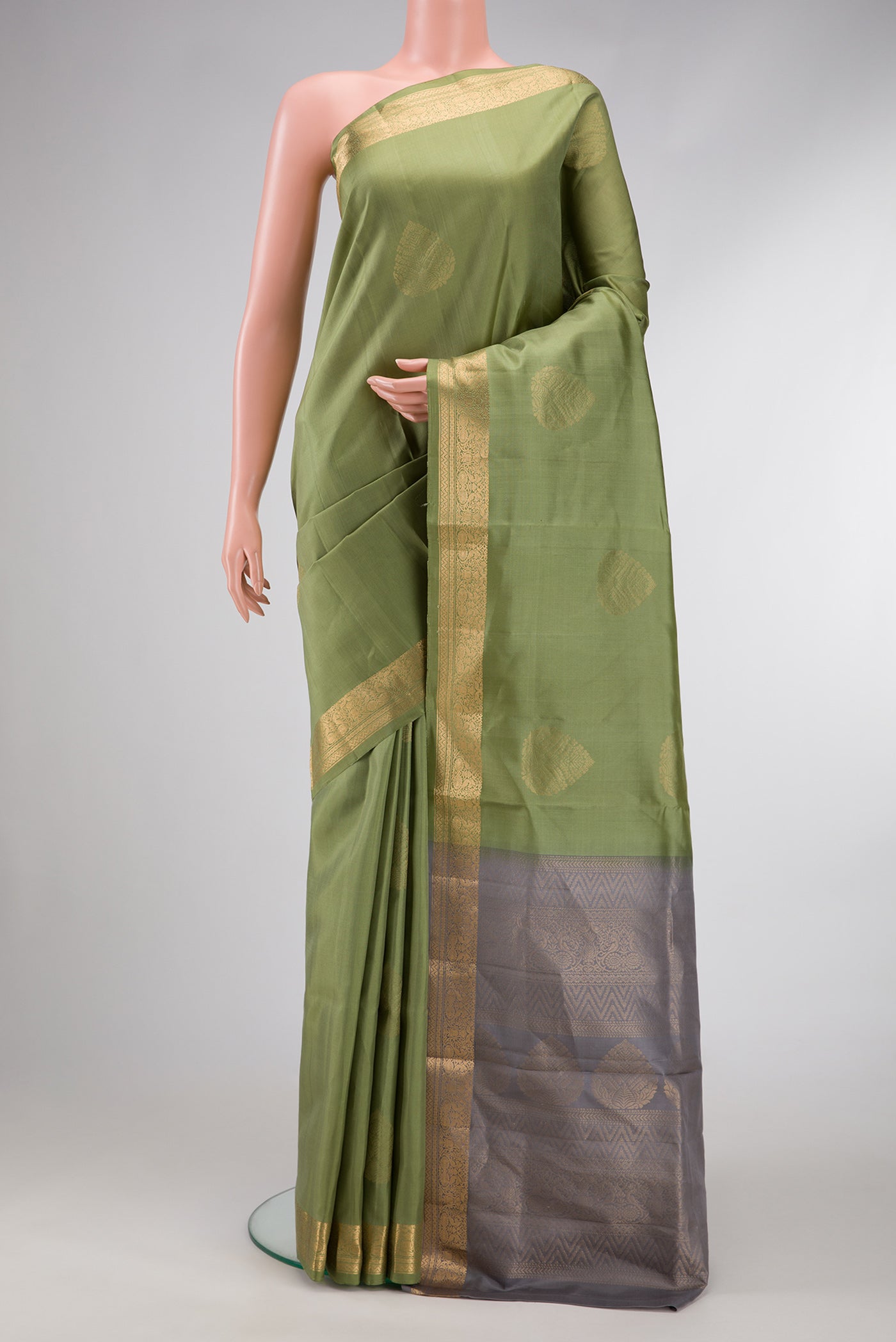 Mehandi Green Dual Tone Soft Silk Saree with Zari Butta on the body and Zari Border.  displayed on a mannequin