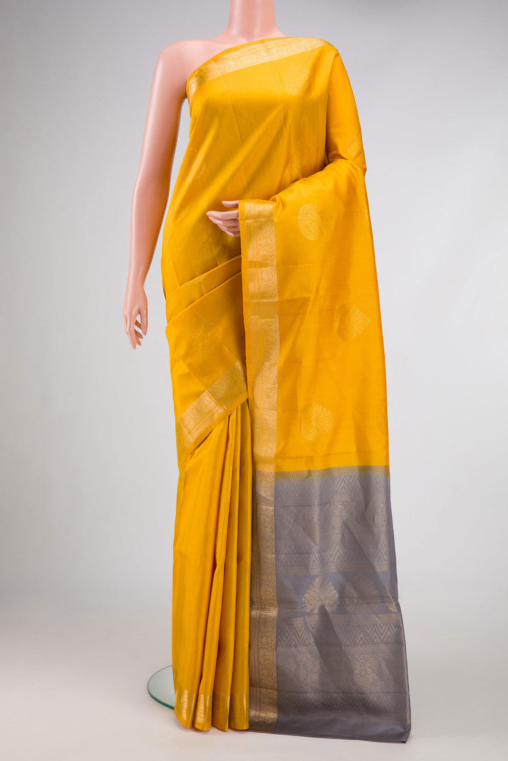 Mustard Dual Tone Soft Silk Saree with Zari Butta on the body and Zari Border.  displayed on a mannequin