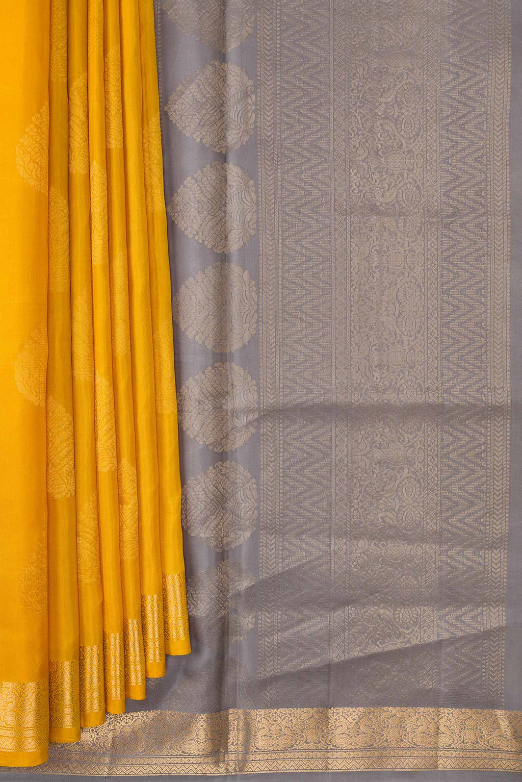 Pleats and pallu of Mustard Dual Tone Soft Silk Saree with Zari Butta on the body and Zari Border. 