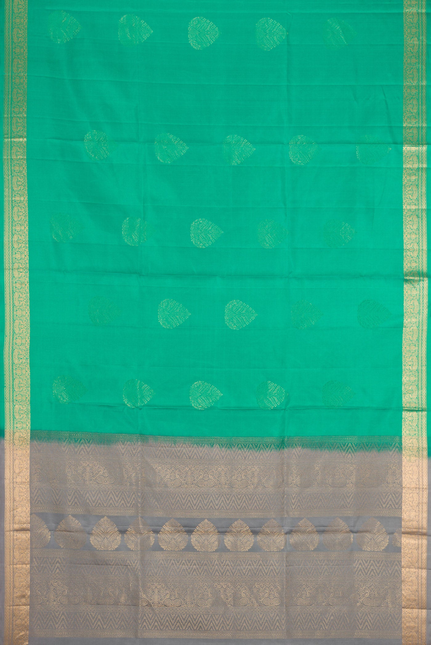 Flat view of Green Dual Tone Soft Silk Saree with Zari Butta on the body and Zari Border. 