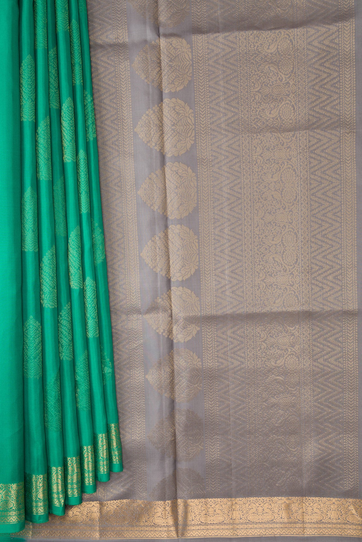 Pleats and pallu of Green Dual Tone Soft Silk Saree with Zari Butta on the body and Zari Border. 