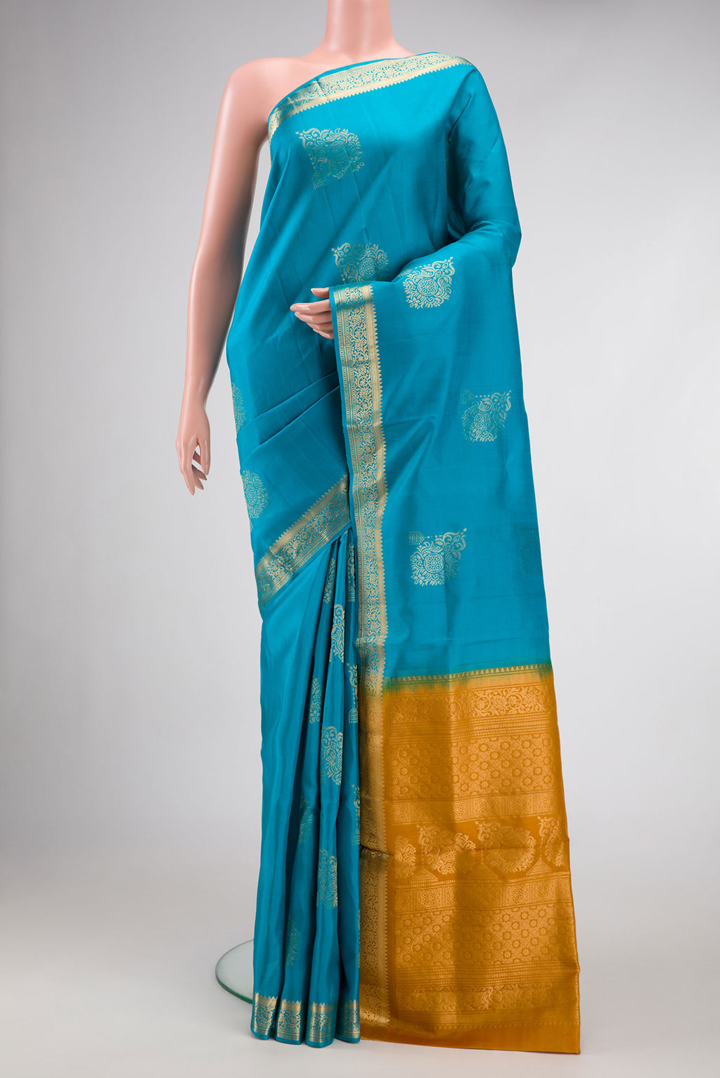 Sky Blue Dual Tone Soft Silk Saree with Zari Butta on the body and Zari Border.  displayed on a mannequin