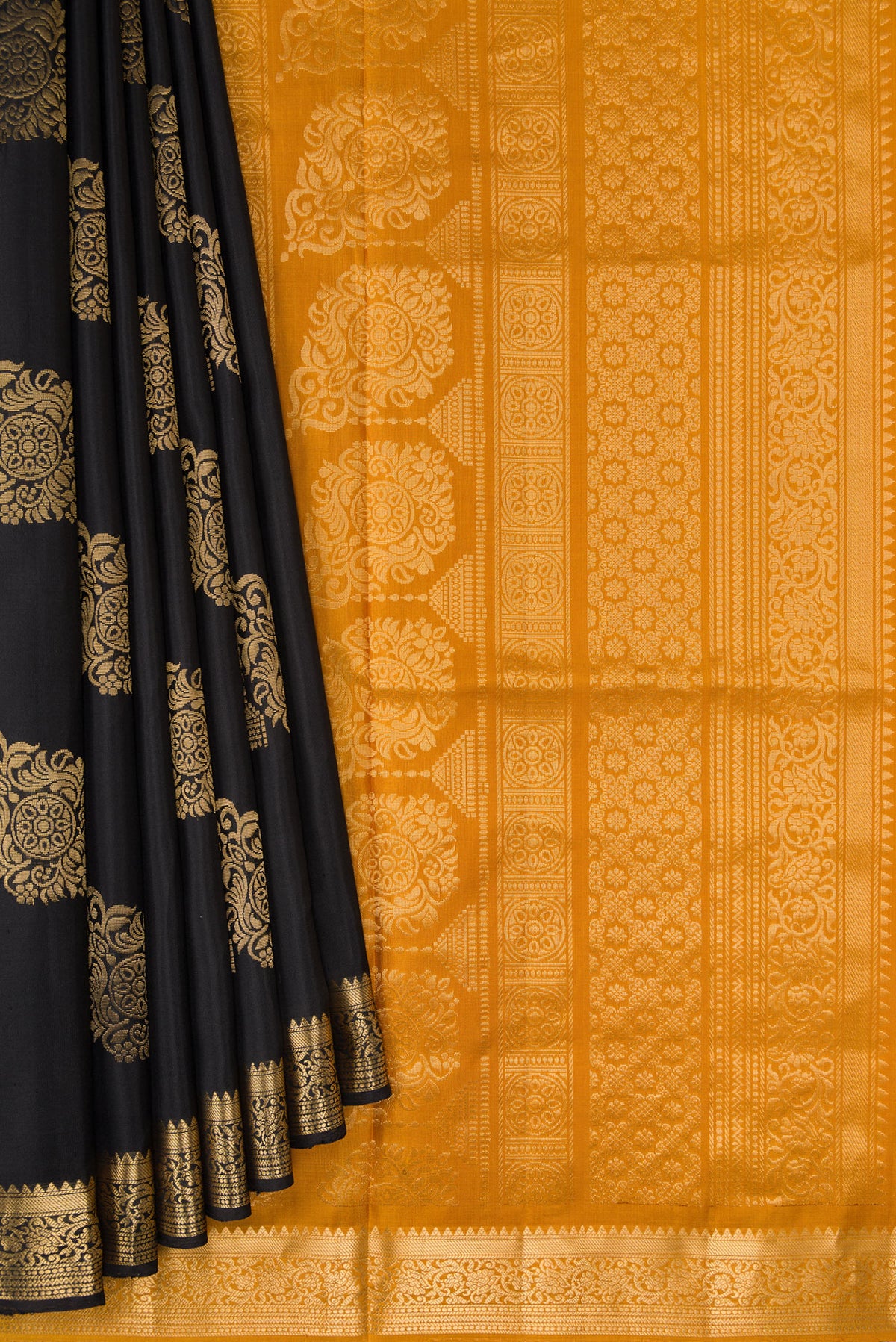 Pleats and pallu of Black Dual Tone Soft Silk Saree with Zari Butta on the body and Zari Border. 