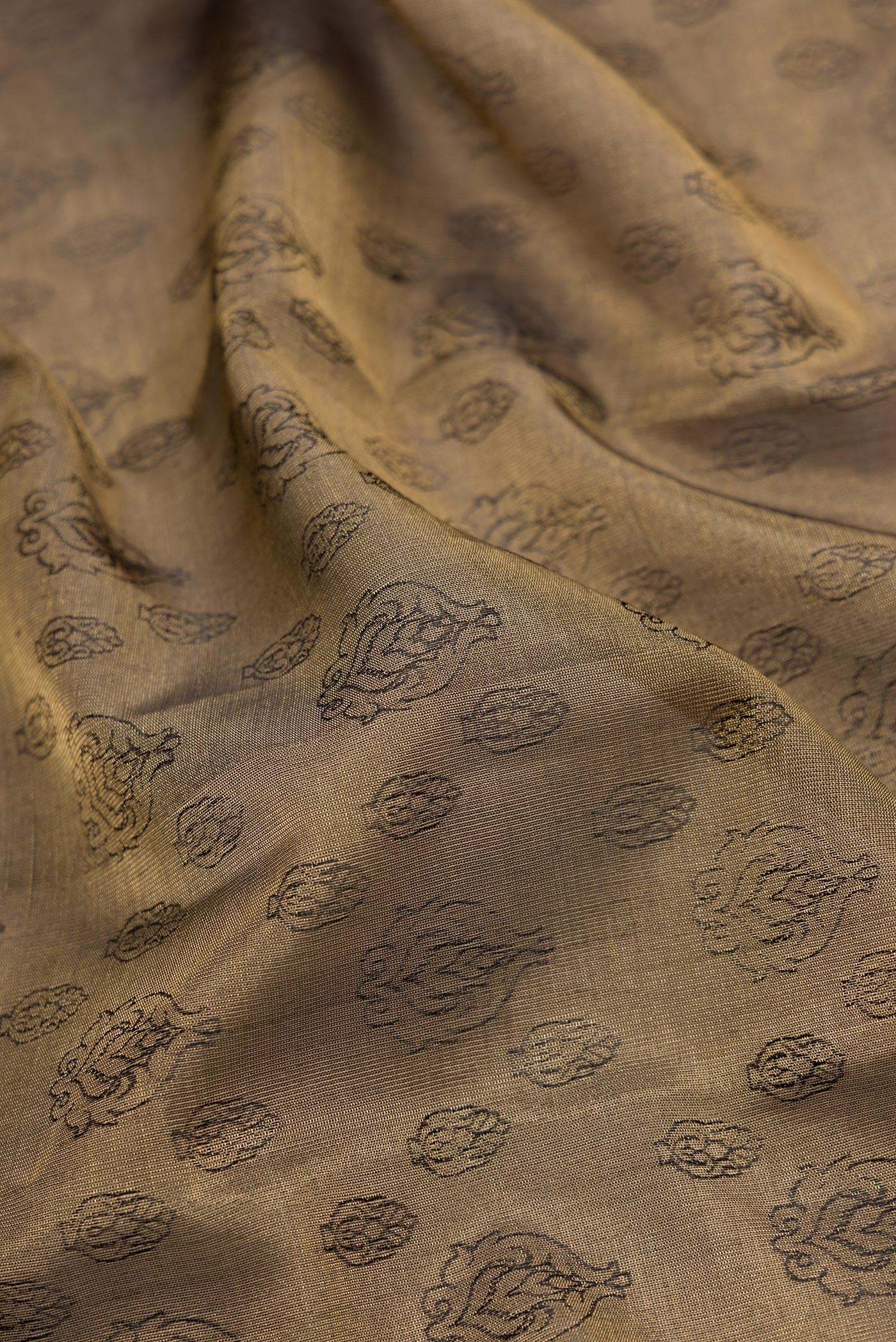 Close up of Gold Dual Tone Kanchipuram Tissue Silk Saree with Zari Brocade on the body and Zari Border.  displaying folds