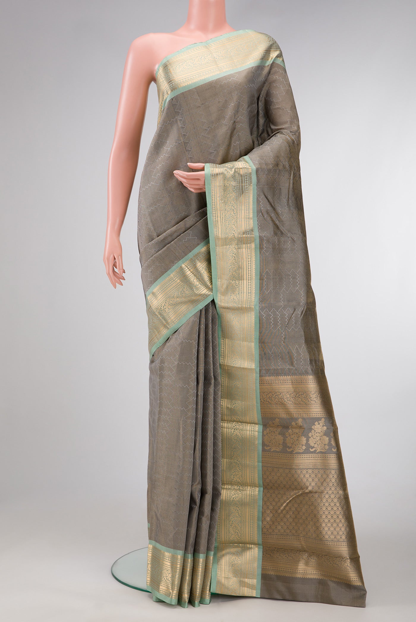 Grey Dual Tone Kanchipuram Tissue Silk Saree with Zari Brocade on the body and Zari Border.  displayed on a mannequin