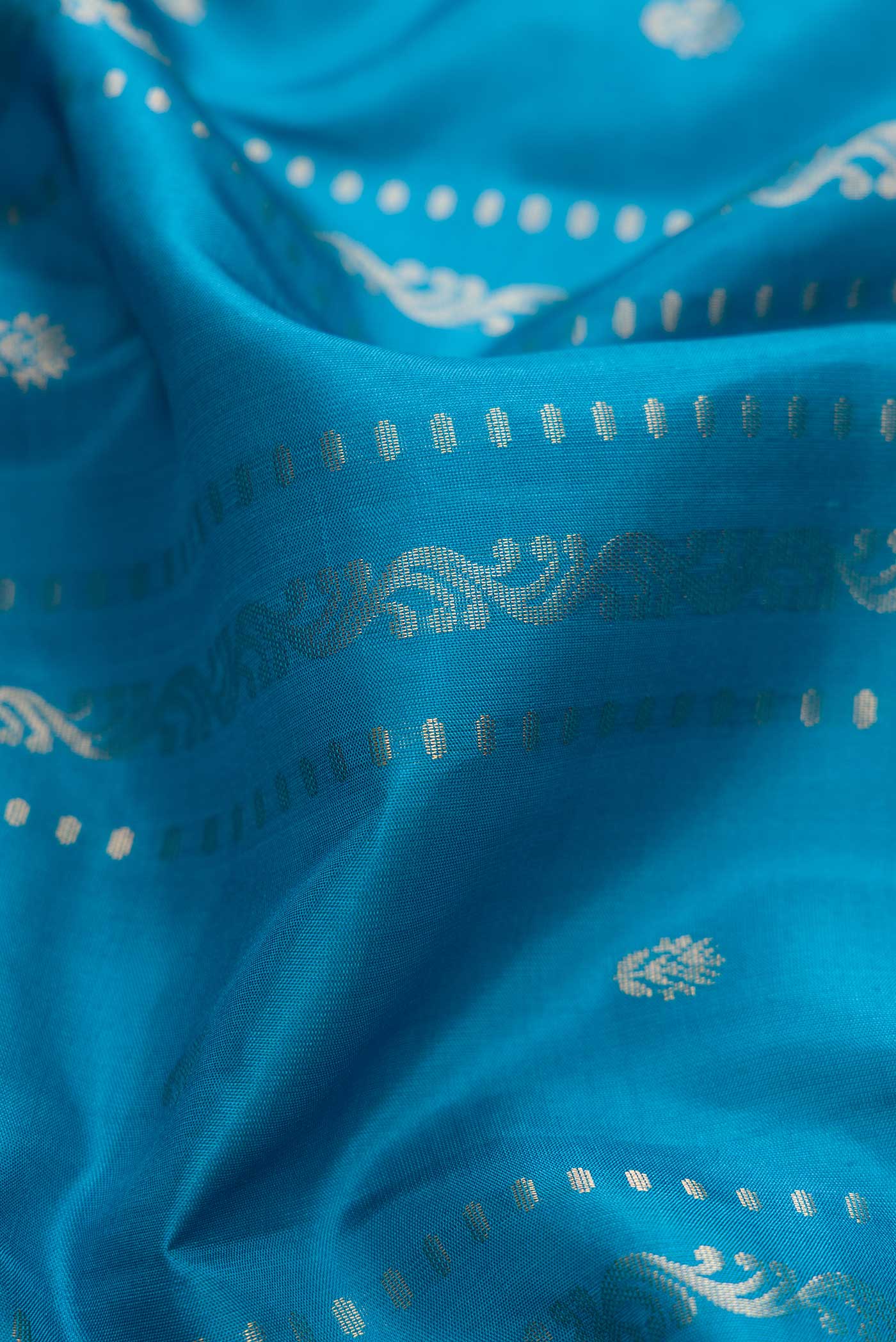 Close up of Blue Dual Tone Soft Silk Saree with Zari Butta on the body and Zari Border displaying folds
