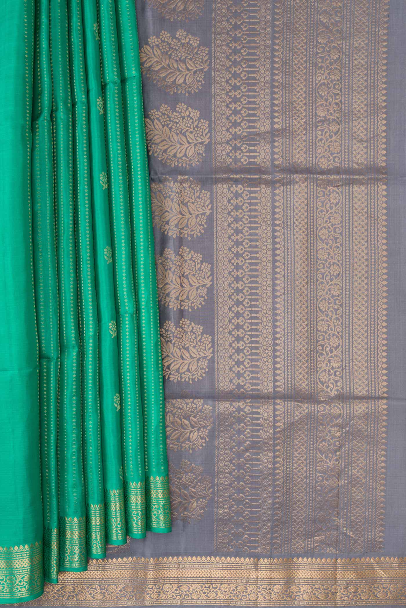 Pleats and pallu of Green Dual Tone Soft Silk Saree with Zari Butta on the body and Zari Border. 