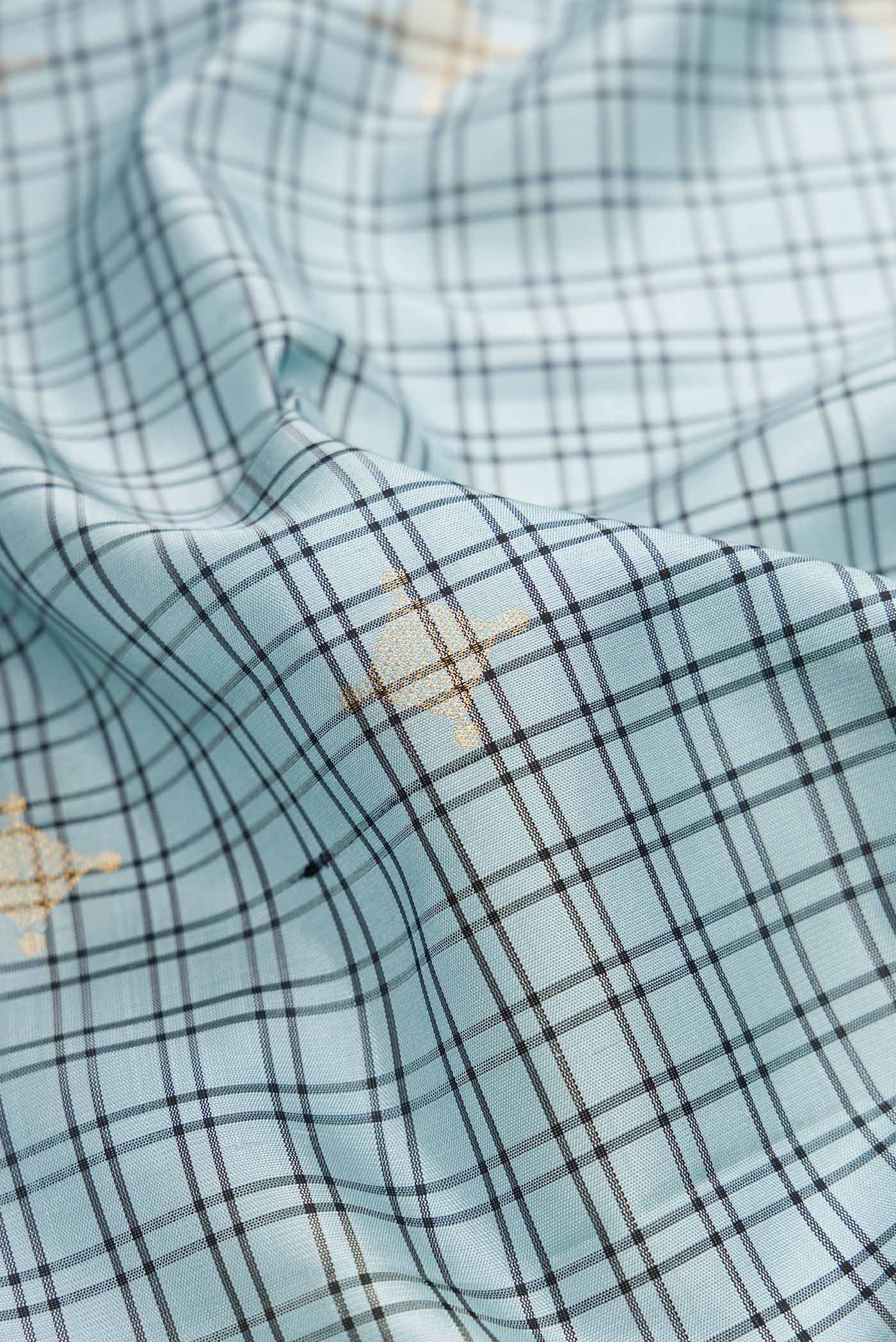 Close up of Grey Dual Tone Soft Silk Saree with Checked design on the body and Zari Border.  displaying folds