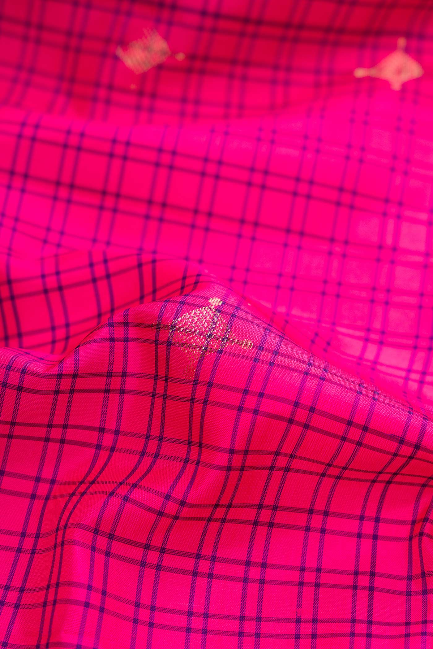 Close up of Pink Dual Tone Soft Silk Saree with Zari Butta on the body and Zari Border.  displaying folds