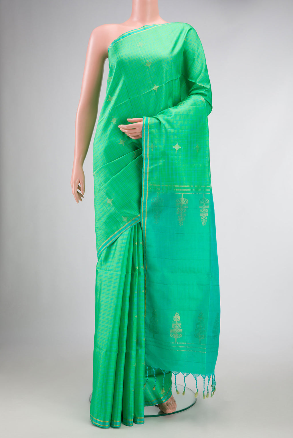 Parrot Green Dual Tone Soft Silk Saree with Zari Butta on the body and Zari Border.  displayed on a mannequin
