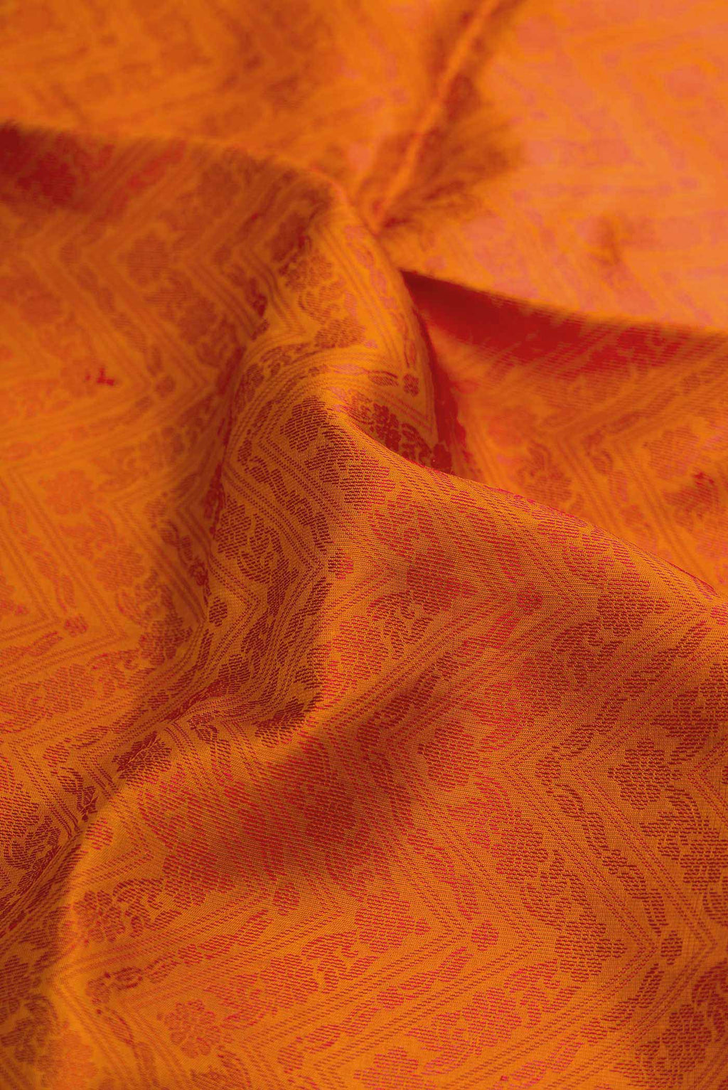 Close up of Orange Dual Tone Soft Silk Saree with Jacquard design on the body and Thread Border displaying folds