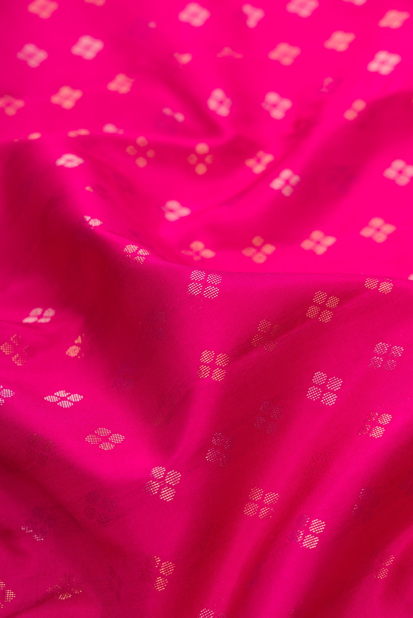 Close up of Dark Pink Dual Tone Soft Silk Saree with Zari Butta on the body and Zari Border.  displaying folds