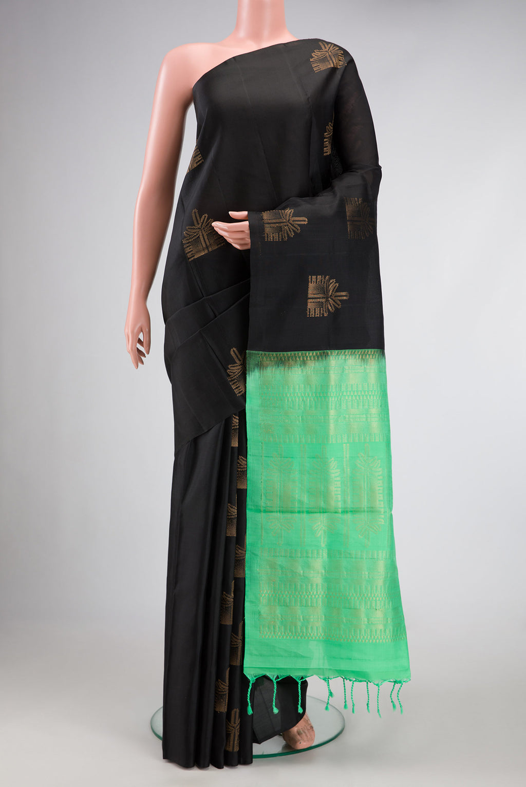 Black Dual Tone Soft Silk Saree with Zari Butta on the body and Without Border.  displayed on a mannequin