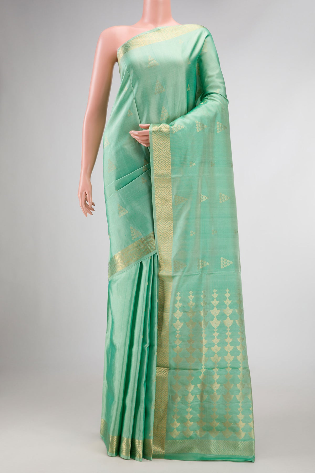 Sea Green Dual Tone Soft Silk Saree with Zari Butta on the body and Zari Border displayed on a mannequin