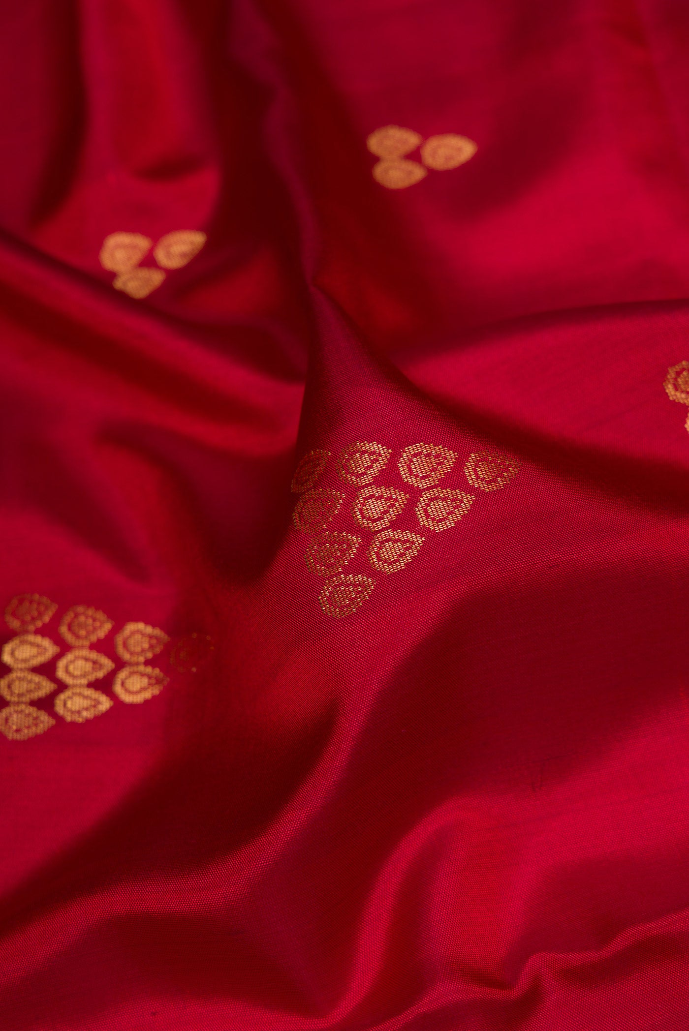 Close up of Maroon Dual Tone Soft Silk Saree with Zari Butta on the body and Zari Border.  displaying folds