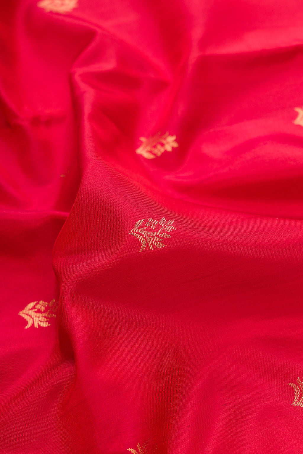 Close up of Maroon Dual Tone Soft Silk Saree with Zari Butta on the body and Zari Border.  displaying folds