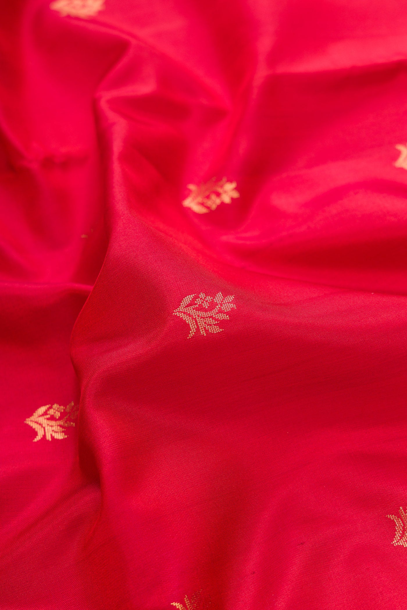 Close up of Maroon Dual Tone Soft Silk Saree with Zari Butta on the body and Zari Border.  displaying folds
