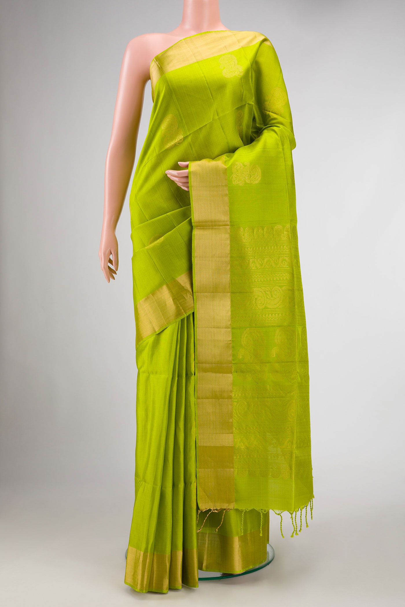 Parrot Green Dual Tone Soft Silk Saree with Zari Butta on the body and Zari Border.  displayed on a mannequin