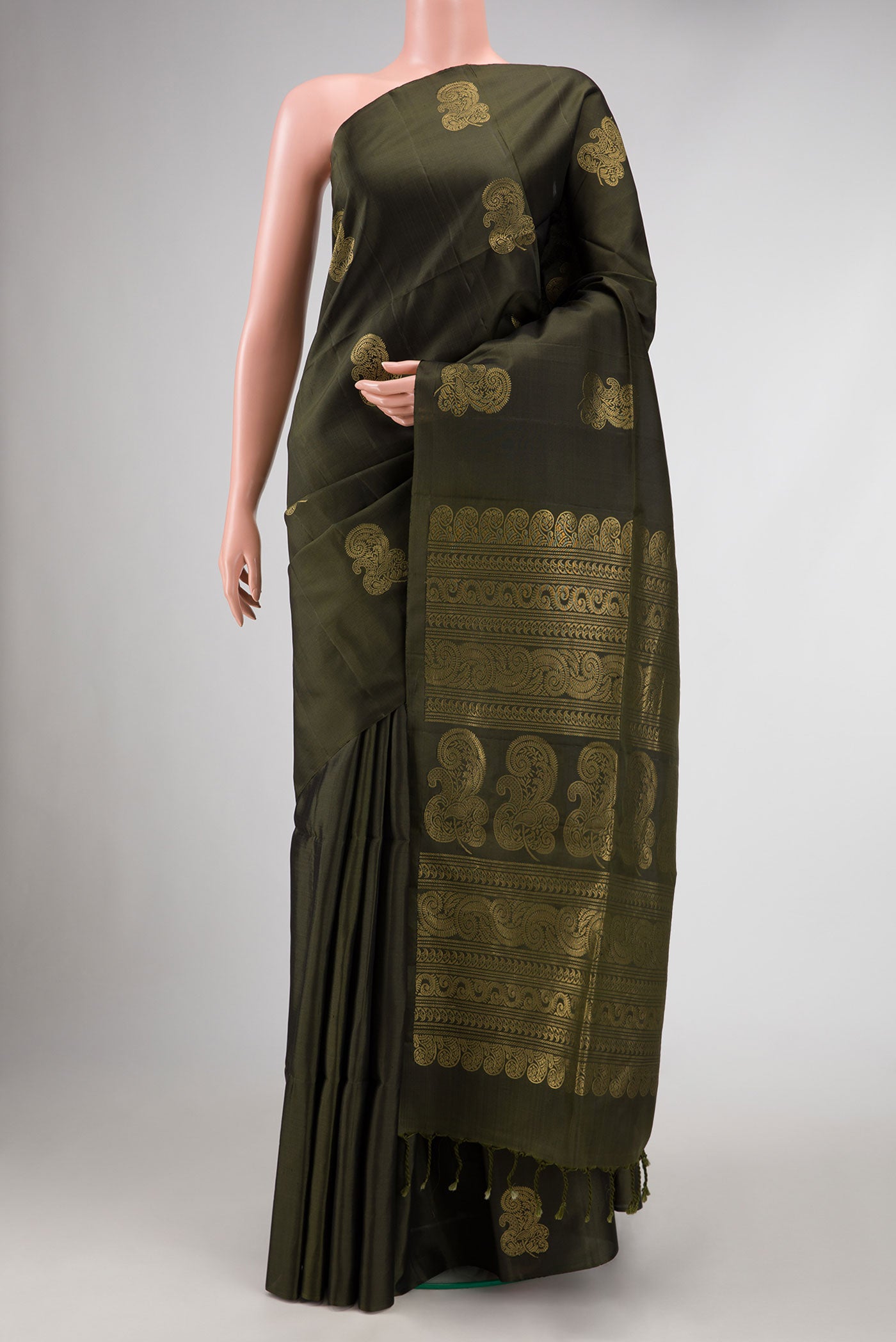 Bottle Green Dual Tone Soft Silk Saree with Zari Butta on the body and Without Border.  displayed on a mannequin