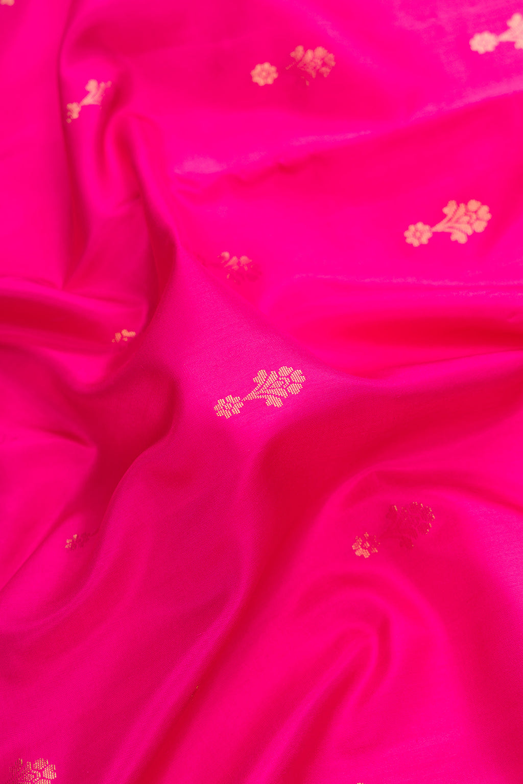 Close up of Pink Dual Tone Soft Silk Saree with Zari Butta on the body and Zari Border.  displaying folds