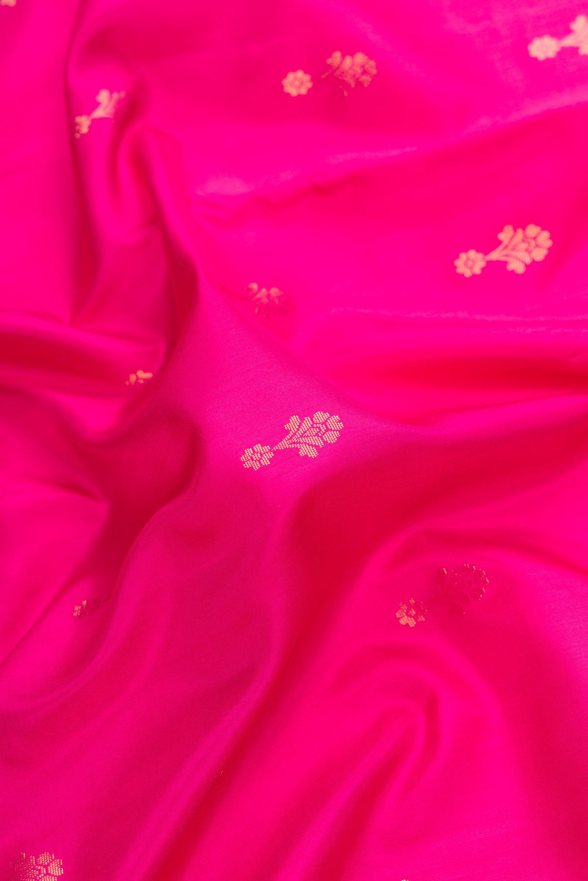 Close up of Pink Dual Tone Soft Silk Saree with Zari Butta on the body and Zari Border.  displaying folds