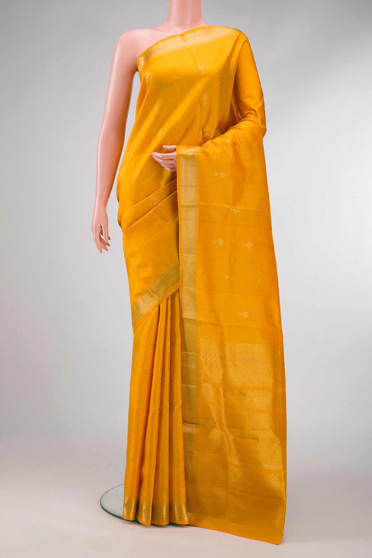 Mustard Dual Tone Soft Silk Saree with Zari Butta on the body and Zari Border.  displayed on a mannequin