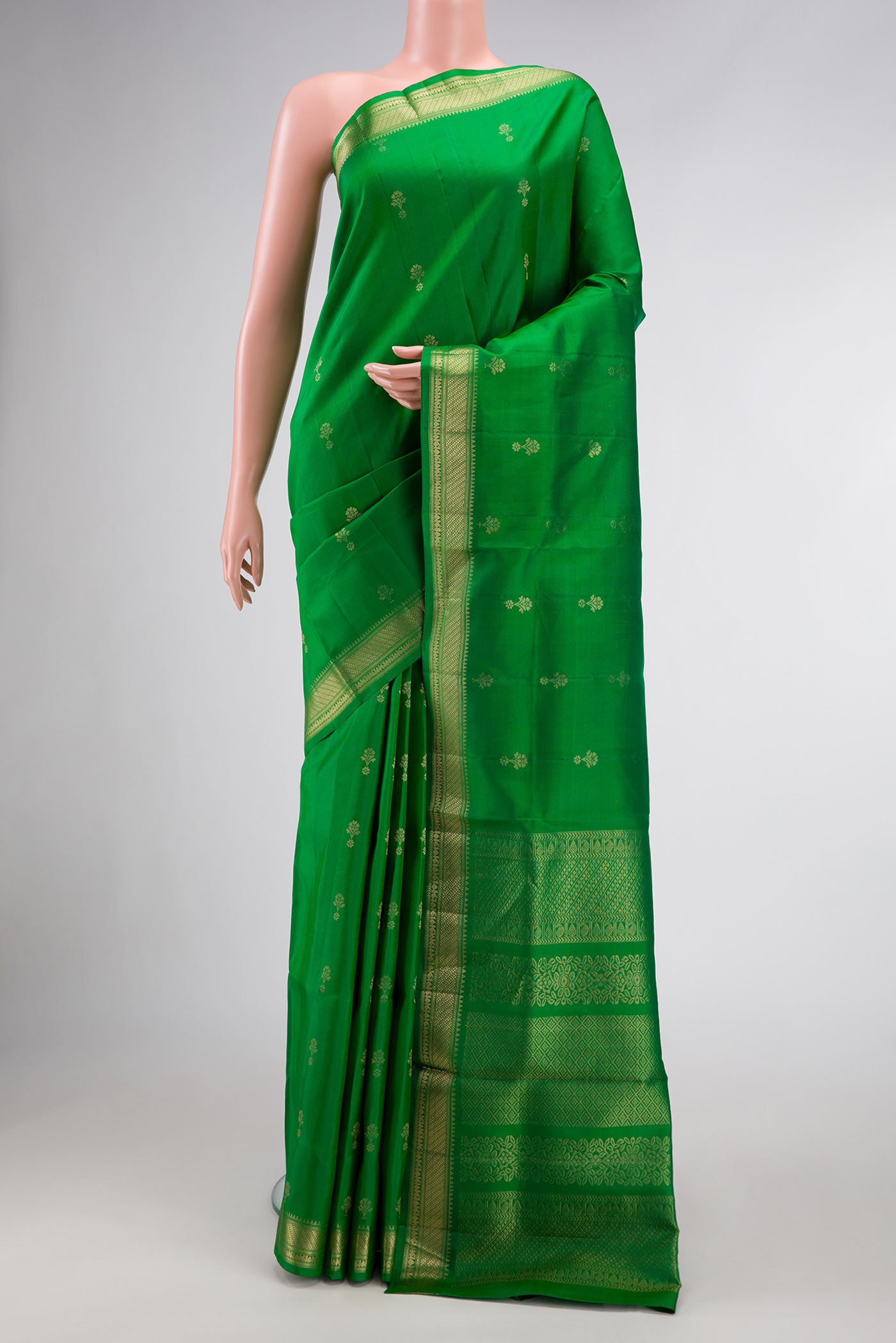 Green Dual Tone Soft Silk Saree with Zari Butta on the body and Zari Border.  displayed on a mannequin