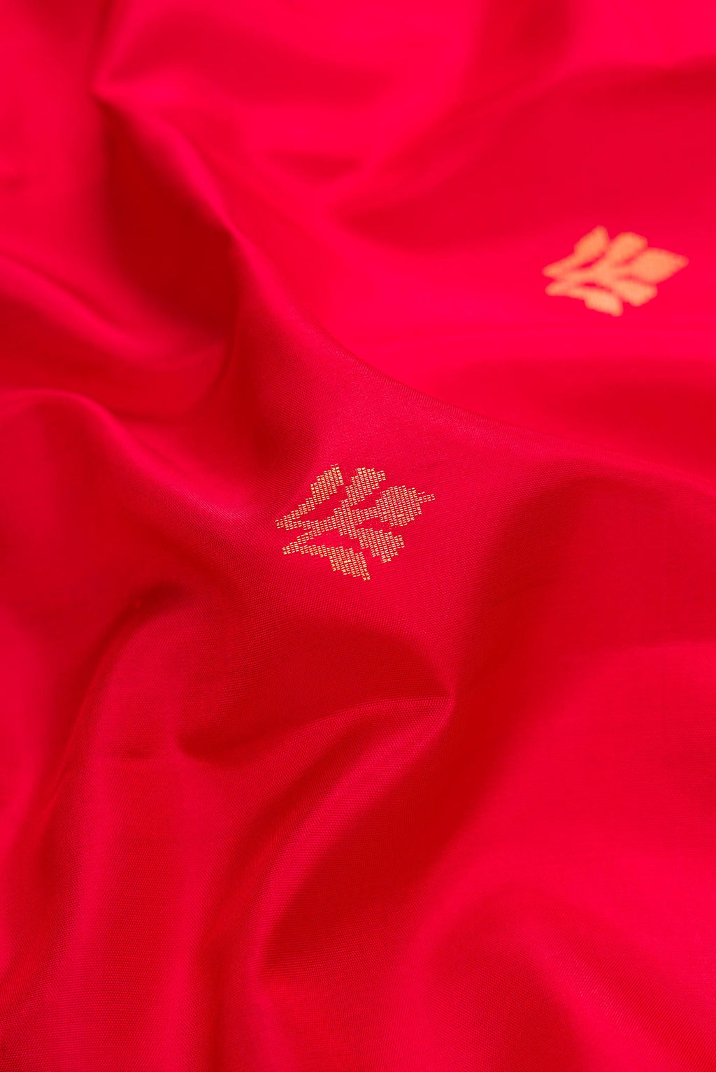 Close up of Red Dual Tone Soft Silk Saree with Zari Butta on the body and Zari Border.  displaying folds