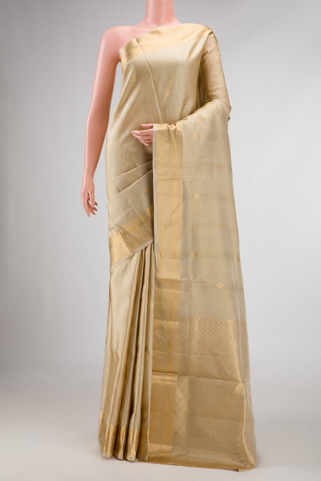 Beige Dual Tone Soft Silk Saree with Zari Butta on the body and Zari Border displayed on a mannequin