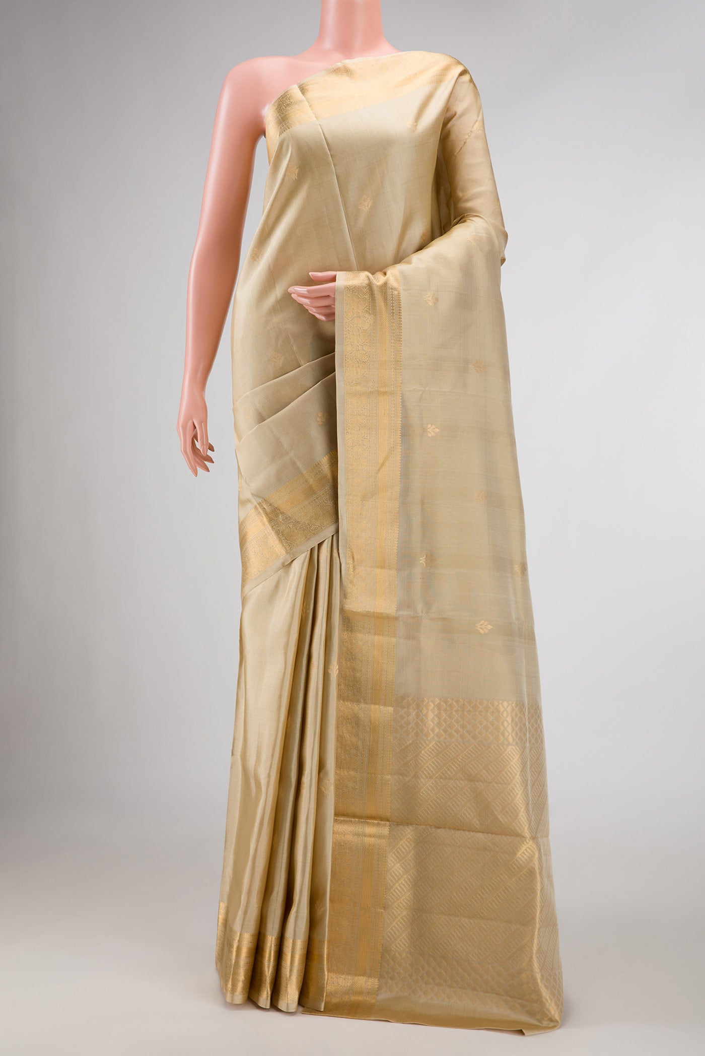 Beige Dual Tone Soft Silk Saree with Zari Butta on the body and Zari Border displayed on a mannequin
