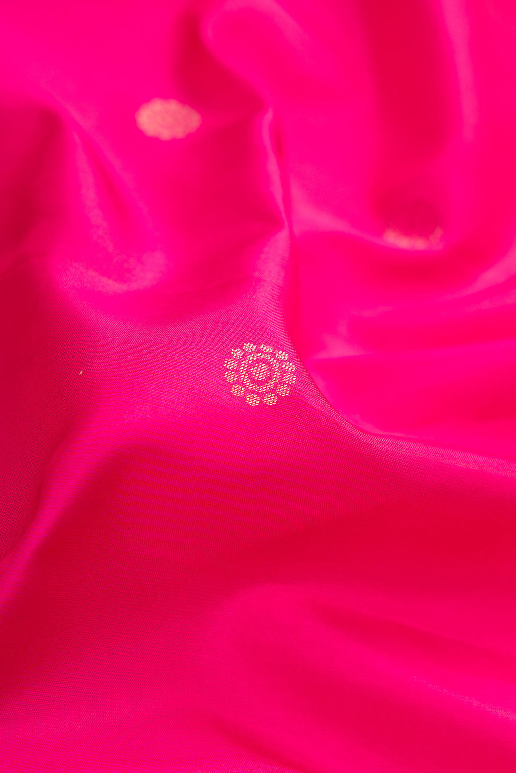 Close up of Pink Dual Tone Soft Silk Saree with Zari Butta on the body and Zari Border.  displaying folds