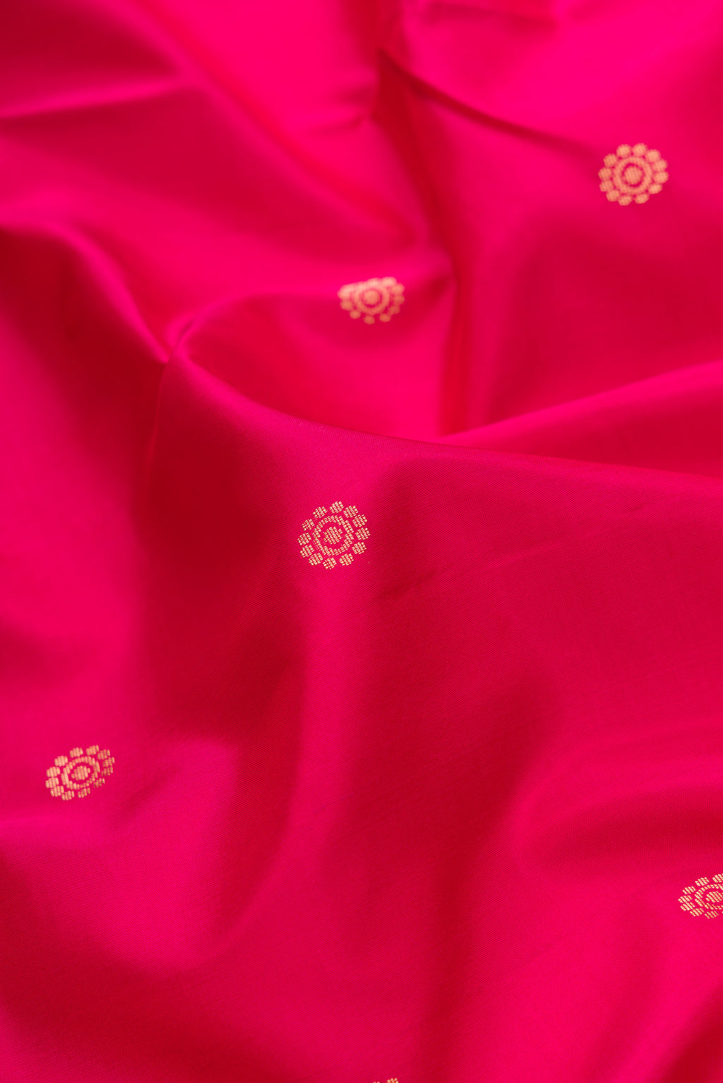 Close up of Pink Dual Tone Soft Silk Saree with Zari Butta on the body and Zari Border.  displaying folds