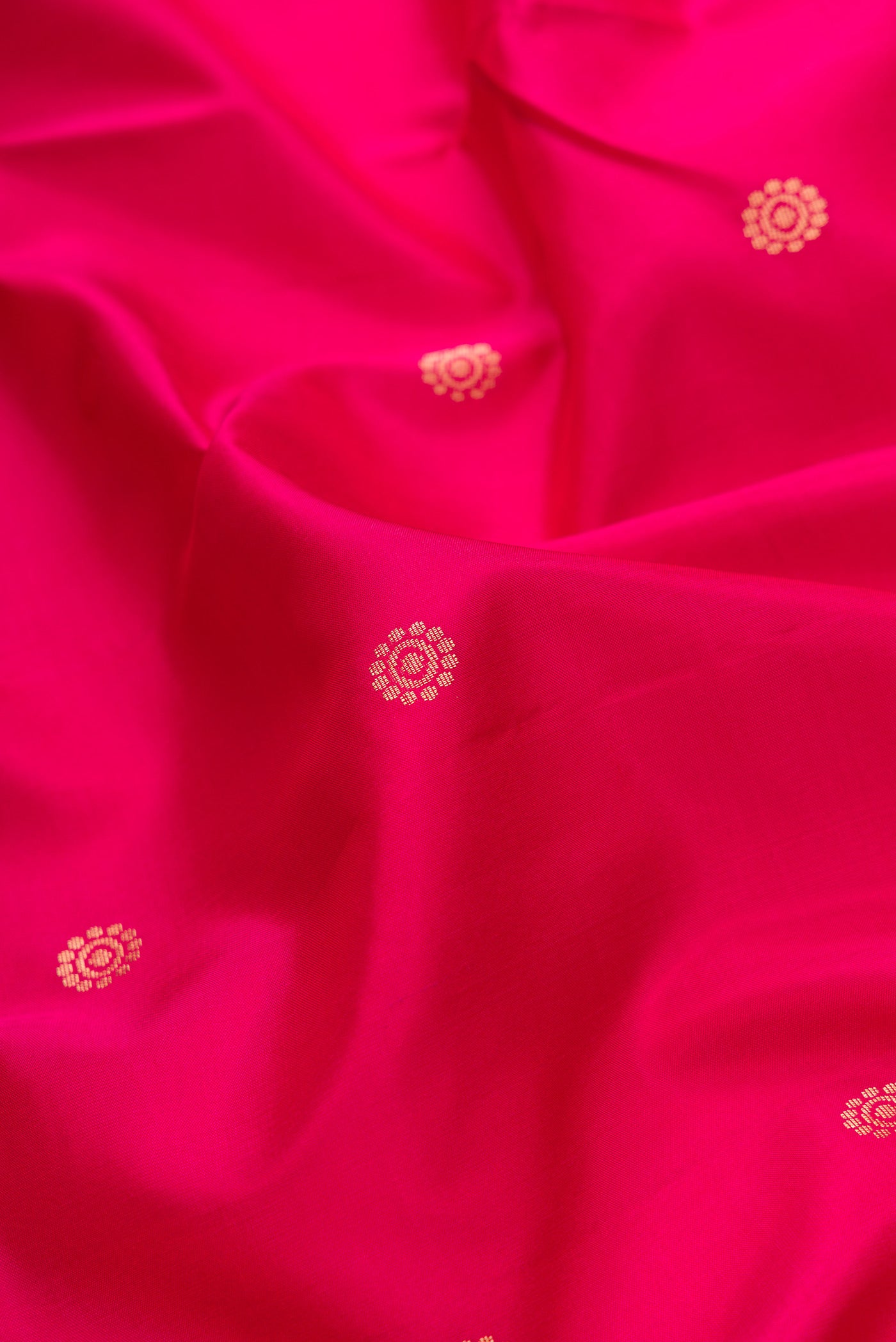 Close up of Pink Dual Tone Soft Silk Saree with Zari Butta on the body and Zari Border.  displaying folds